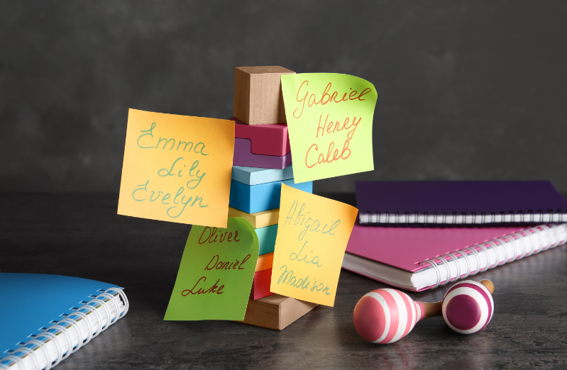 Baby names on colorful post-its, wooden blocks and notebooks