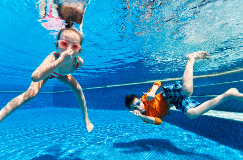 Kids underwater in pool